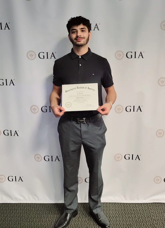 Ali Assi holding his GIA certificate