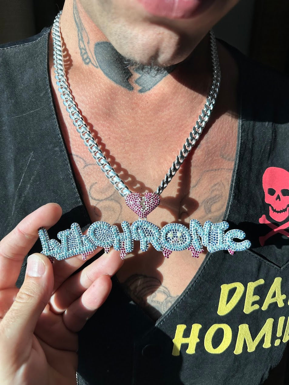 Hands holding an open box with a silver pendant on a chain