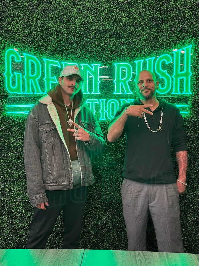Ali Assi and Miguel Asmar in front of the Green Rush Nation neon sign
