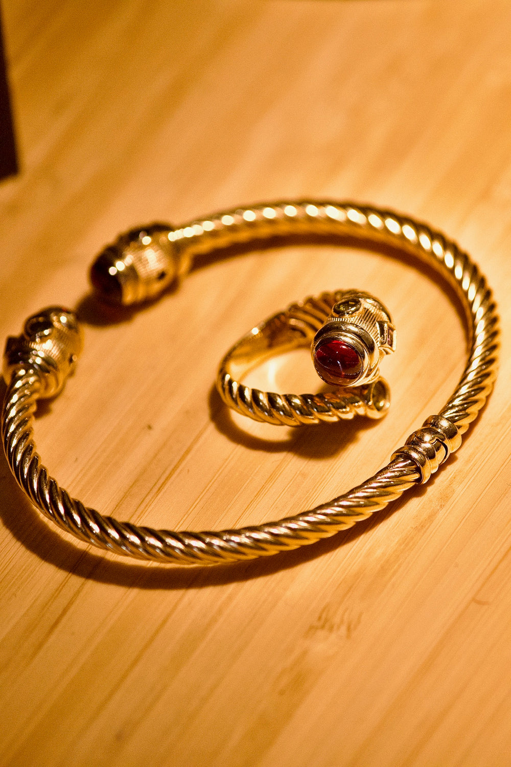 Gold cuff and a ring with a red stone