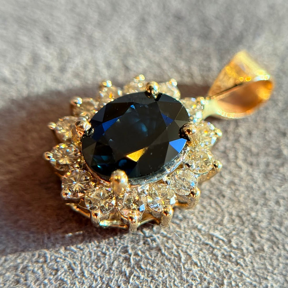 Sapphire pendant with a diamond halo