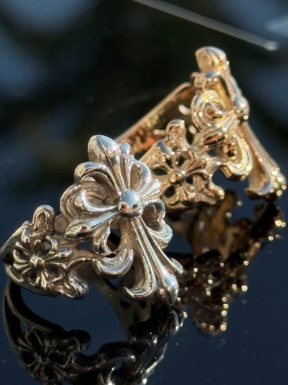Fleur-de-Lis Cross Ring in sterling silver, beside the gold version · Lukali & Co