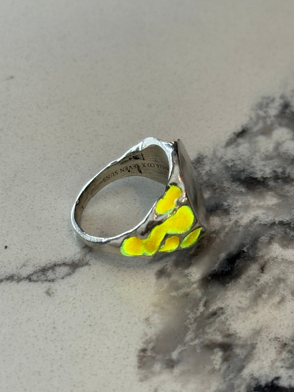 Silver band with blue glow enamel set into its rough surface